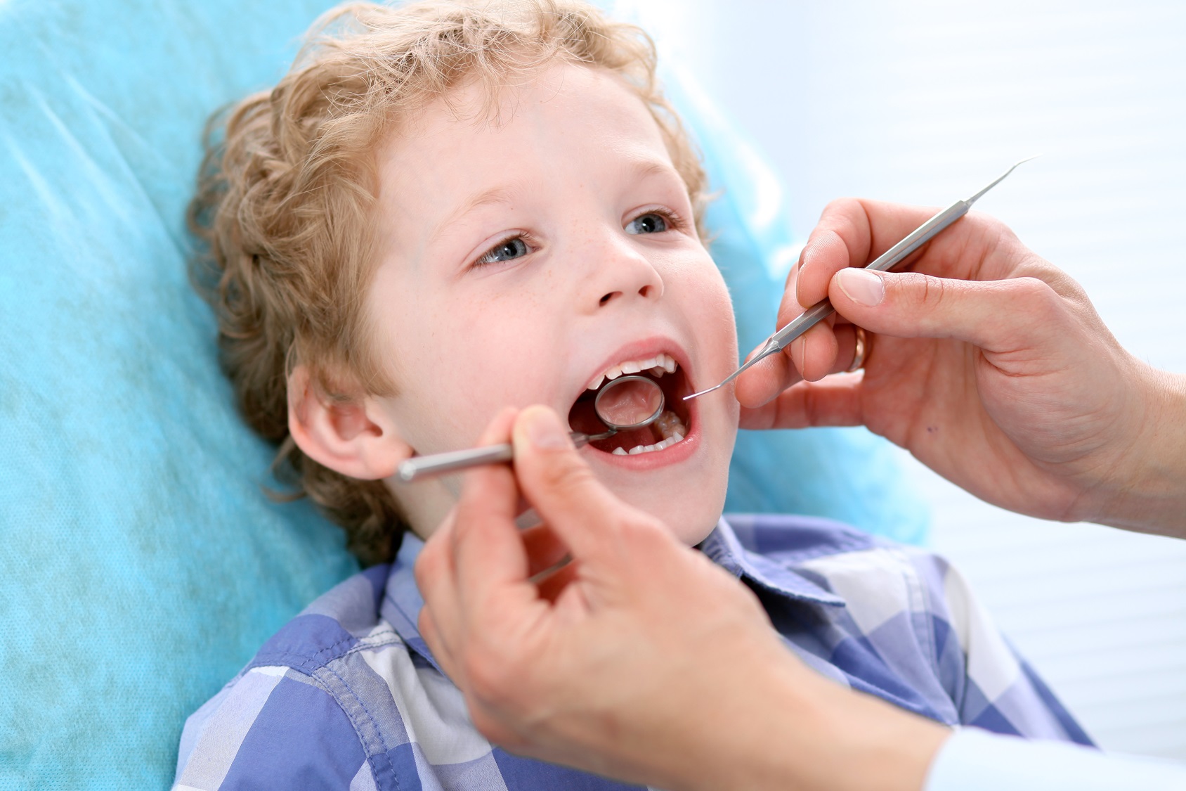 close-up-of-boy-having-his-teeth-examined-by-a-dentist