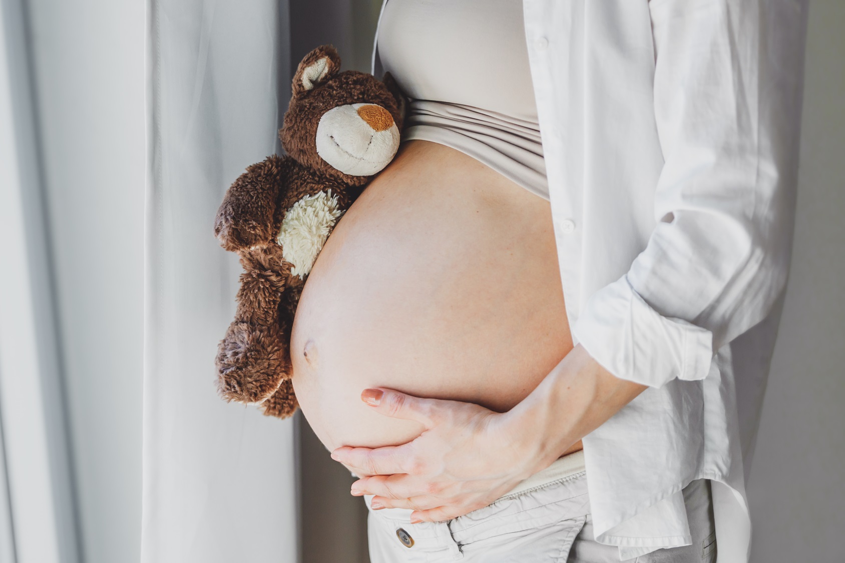 pregnant-woman-with-toy-teddy-bear-listening-baby-lifestyle-maternity-concept